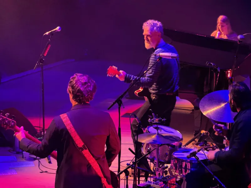 Shot from the side of the stage. Glen Hansard playing guitar, Markéta Irglová is at the piano. There's also a bass player and drummer