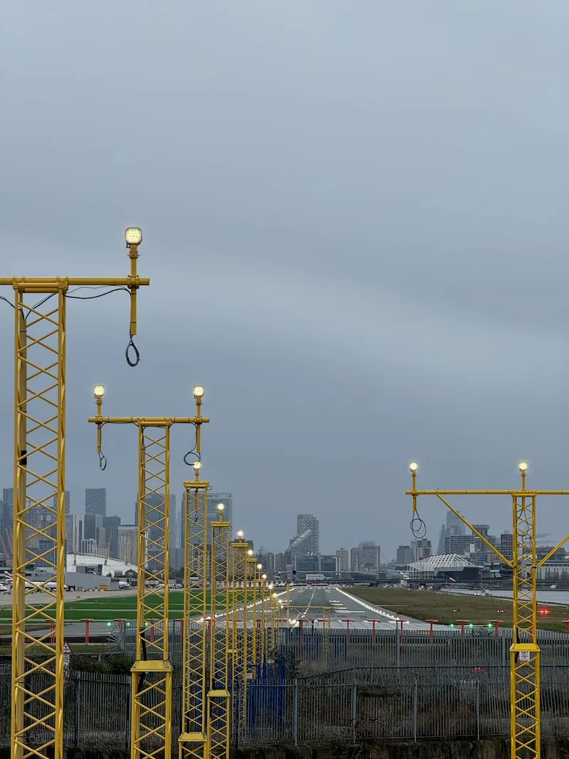 Looking straight down the runway at London City Airport with Canary Warf in the distance