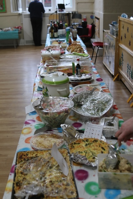 A long table full of home made food and decorated for a party