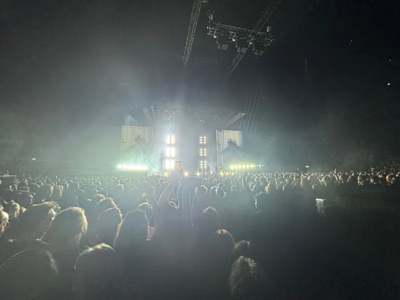 Wide shot of the area with might lights streaming off the stage.