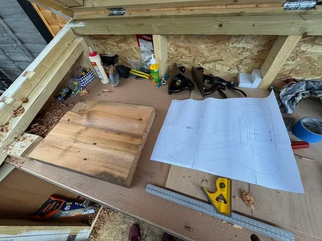 Planing the guitar body to create a flat surface.